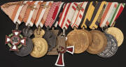 OFFICER'S GROUP (Austro-Hungarian): A life time of service to the Empire. Left to right; Cross of Military Merit 3rd class (war decorations & swords); Medal of Military Merit (2) one bronze one silver; Karl Troop Cross; Combatants Cross; Medal of Honour o