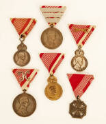 Collection of Austro-Hungarian Medals: Noted, Iron Cross of Merit (2, one with crown); Wounded Medal (6); Karl Troop Cross; Silver Bravery 1st class (3); Military Medal of Merit in Silver (2) & one in gilt bronze. VG condition.