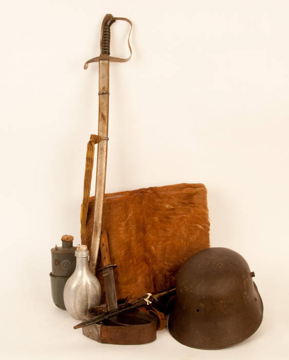 Trench warfare group: Stahlhelm (helmet); Trench knives (2); Sword & scabbard; belts & buckles (2); fur pack; flasks (2); dish. G/VG condition.