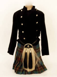 Scottish Regalia: Hand stitched black velvet double brested jacket with white metal thistle buttons; pleated kilt and sporran on a vintage wooden based shop mannequin. 150cm tall, fair/good condition.