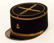 French Kepi peaked cap, iconic flat circular top adorned with gold embroidered anchor and piping, made by "Macovel Le Puy"; French Naval hat in navy blue with embroidered anchor and red piping (no name band), mid 20th century. VG condition.