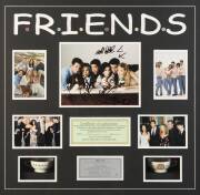 FRIENDS, display comprising colour photograph signed by 6 cast members - Jennifer Aniston, David Schwimmer, Courteney Cox, Matthew Perry, Lisa Kudrow & Matt LeBlanc, window mounted with 4 other photos & 2 tea-cups, framed & glazed, overall 75x73cm. With C