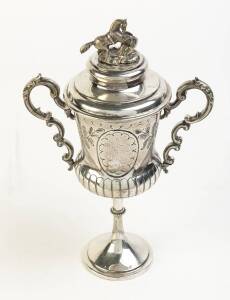 1899 SHOOTING TROPHY, silver-plated trophy cup with two handles, and lid with prancing horse finial, engraved "1 C.K.R.R./ E Coy/ F.H.McDonnell, 2nd Shot, 1899". Overall 30cm tall.