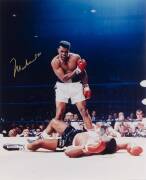 MUHAMMAD ALI, signed colour photograph of Ali standing over Sonny Liston, size 41x51cm. 