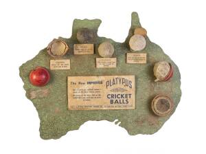 PLATYPUS CRICKET BALLS: c1950s advertising board in shape of Australia with partially made cricket balls affixed (couple missing), and text "The New Improved PLATYPUS Cricket Balls. Made in Australia and scientifically designed to specially suit New Zeala