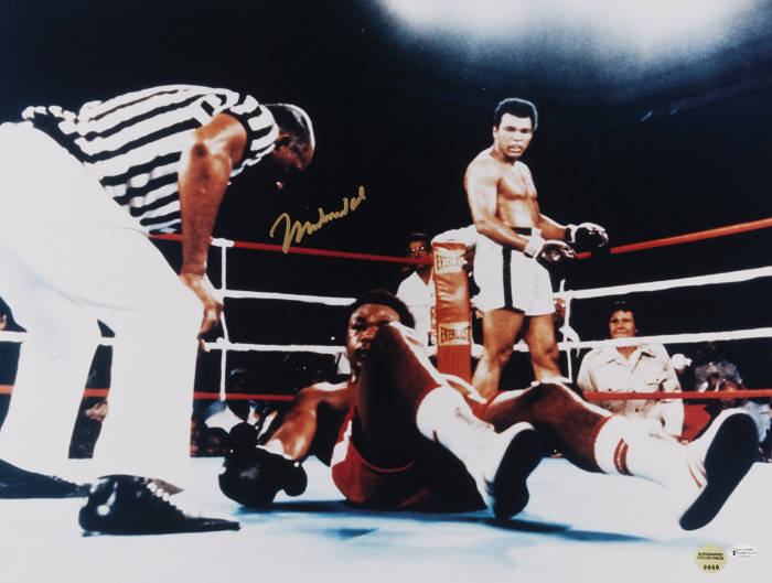 MUHAMMAD ALI signed colour photograph of Ali standing over George