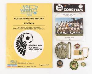 FOOTBALL GROUP, noted c1890s belt buckle showing footballers; Manchester United badge; Saudi arabia Football Federation badges (8) & key-rings (3); 1981 NZ team for World cup coasters pack (unopened); 1986 Countrywide NZ v Australia programme.