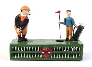 "BIRDIE PUTT", mechanical coin bank toy, with spring-action button making golfer hit a coin and sink it in hole, whilst caddy moves flag-stick out of the way. Appears to be a replica of 1920s toy.