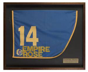 EMPIRE ROSE (winner 1988 Melbourne Cup, 2nd in a bumpy finish in 1987), display comprising saddlecloth she wore in 1987 Melbourne Cup, framed & glazed, overall 78x65cm.