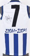 ADAM SIMPSON (North Melbourne), signature on North Melbourne football jumper with number "7".