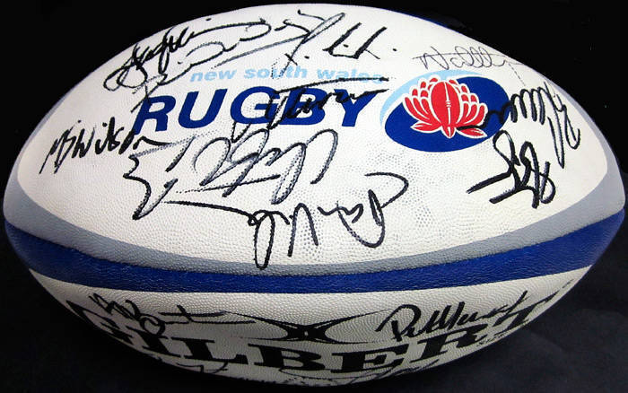 FOOTBALLS: Collection with signed 2003 World Cup football; signed NSW Rugby football; signed Illawarra Rugby footballs (3); Gilbert football with faded signatures; other footballs (5); mini-footballs (7); also "Wales - Grand Slam Winners 2005" framed disp