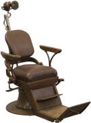 Vintage dentist's chair together with a foot pedal powered dental drill.