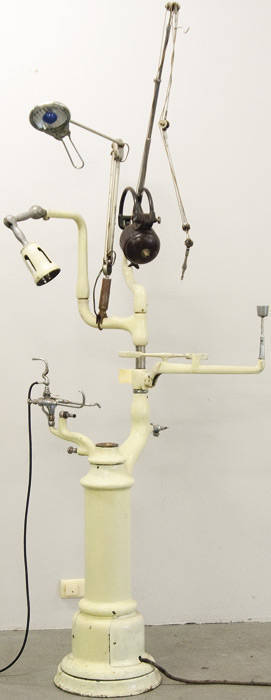 Vintage dentist's pedestal with associated motor driven drill, gas burner attachment, lights, etc.