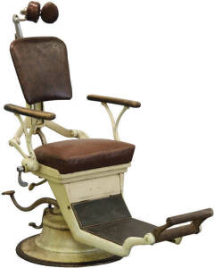 Vintage adjustable dental chair with associated side stand.
