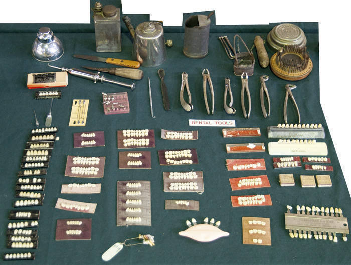 A range that includes false teeth, various vintage tools including forceps, etc.