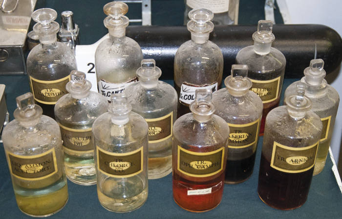 DISPENSING BOTTLES with polished pontils, labels, 25cm and taller, all in good condition with stoppers.