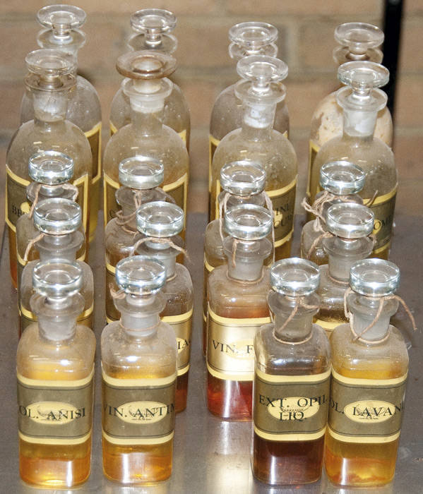CHEMIST'S DISPENSING BOTTLES, with painted & printed labels, full polished pontil, in two sizes - 12cm & 18cm. All in good condition.