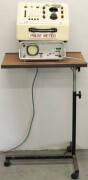 "Armoured Ellisco Sphygmomanometer - Centennary model" by Elliotts Australian Drug Pty Ltd on wheeled trolley.
