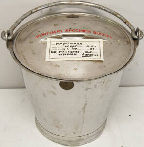 Stainless steel lidded bucket labelled "Mortuary Specimen Bucket" which appears to have last contained the kidneys of a Mr McNabb.