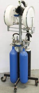 Anaesthetic apparatus by C.I.G. with 4 cylinders on a 4 wheeled moveable stand.