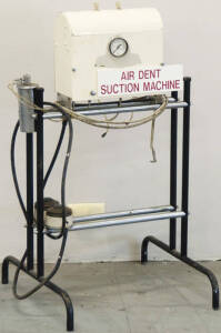 Suction Machine by Air Dent on small metal frame.