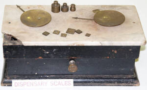 Large dispensary scales with some weights, attached to a marble and wooden box. Faults.