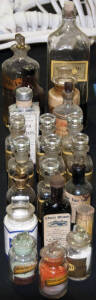 DISPENSING BOTTLES, with polished pontils, labels, 15cm tall, all in good condition & all with plain stoppers.