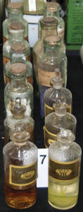 12 glass pharmacy bottles.