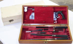 Wooden box containing tools used in plaster and splint making. Includes various saws (incomplete) together with similar sized wooden box (empty).