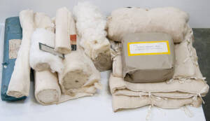 Trio of padded chest jackets and eight absorbent bandages, gauze and lint.