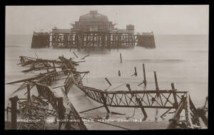 Subjects/Themes (Great Britain) - GRAND PIERS: Two albums of mostly Golden Age cards with several court-size cards & numerous real photo types including destruction of piers at Southsea (1904), Worthing (1913), Hastings (1917) x2 & Morecombe (1903, artist
