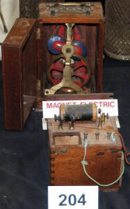 Vintage magneto electric machine in wooden box plus another.