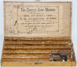 Print label kit by "The Thistle Sign Maker" contains set of rubber stamps in wooden box. Appears complete.