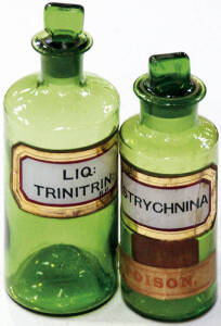 Pair of green glass bottles with stoppers, one contained "strychnina" and the other contained "liq. trinitrin".