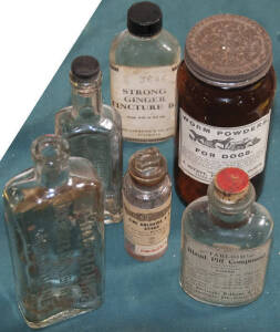 Six larger glass bottles used to contain for example "Zinc Chloride", "Strong Ginger Tincture", "Worm Powders for Dogs" etc.