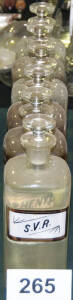 DISPENSING BOTTLES: with polished pontils, painted and printed labels, 23cm tall, all in good condition & all with stoppers.