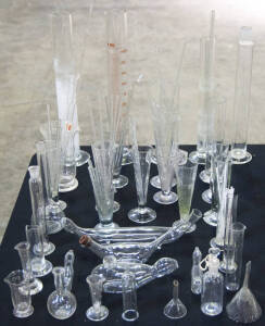 Range of glass items including various sized beakers and mixing straws.