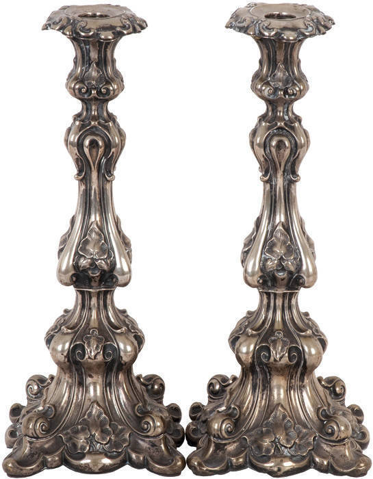 Antique Continental Silver candle sticks. An ornate pair with foliate scrolling design. Hollow base. Some minor damage (small dents). 34cm, 650grams. Fair condition.