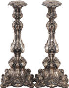 Antique Continental Silver candle sticks. An ornate pair with foliate scrolling design. Hollow base. Some minor damage (small dents). 34cm, 650grams. Fair condition.