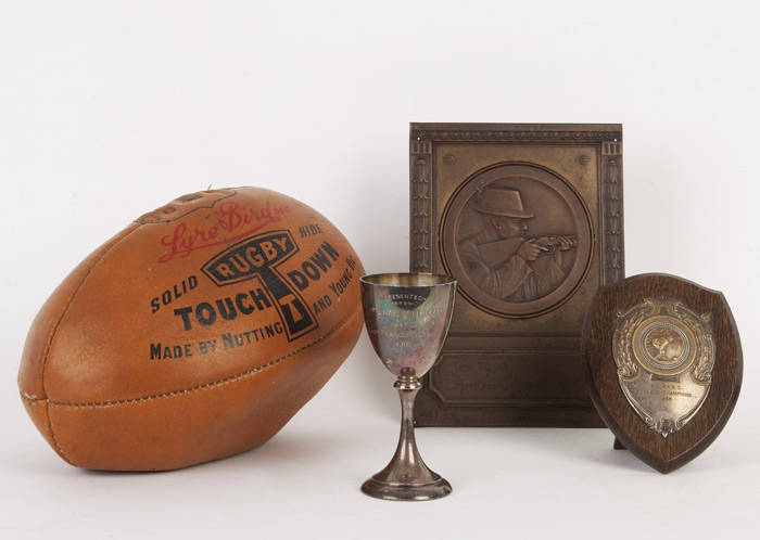 TROPHIES & RUGBY FOOTBALL: Silver-plated goblet "presented to Michael Litrizza by Capt.Francis G.Dineley RN 1905"; 1938 German shooting trophy; 1956 Lawn Bowls trophy; "Lyre Bird" rugby football made by Nutting and Young Vic.