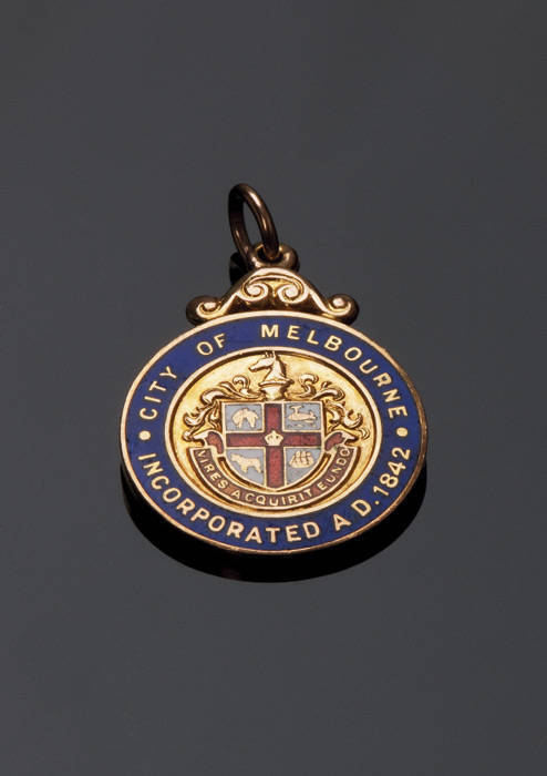 "City of Melbourne Incorporated A.D 1942", 9ct gold and enamel fob, reverse engraved with the number 135, by Stokes. VG condition.