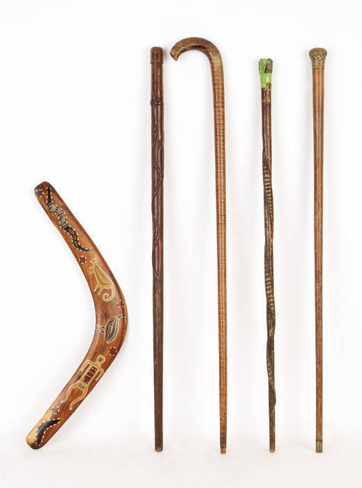 BILL ONUS: Boomerang hand painted by Bill Onus of Belgrave (Victoria) c1950s with ink stamp signature, excellent condition; Plus (4) old walking sticks including fiddleback blackwood, carved snake sticks (2) & a walking cane with ornate brass top. Good co