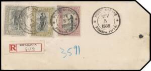 1938 (Nov 5) registered gold bullion parcel tag with Pictorials 9d Fisherman, 5/- Policeman (surface fault) and &pound;1 Hut & Coconut Palm tied 'POST OFFICE/NOV/5/1938/BWAGAOIA PAPUA' rubber d/s & red/black R label alongside from Goldmines of Papua Ltd, Misima