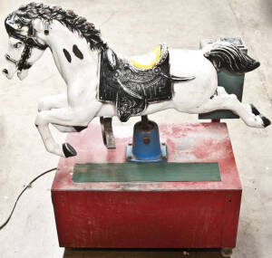 Coin operated childs horse ride machine. Painted fibreglass in yellow, black and white showing signs of wear. In need of restoration. Fair condition.