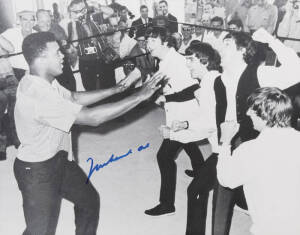 MUHAMMAD ALI & THE BEATLES, photograph of Ali clowning around with The Beatles, signed "Muhammad Ali", size 51x40cm. With CoA.