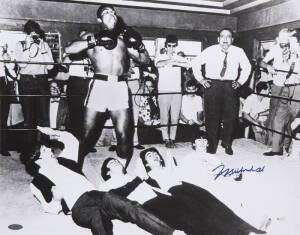 MUHAMMAD ALI & THE BEATLES, photograph of Ali standing over The Beatles, signed "Muhammad Ali", size 51x40cm. With 'Online Authentics' No.OA-0000633.