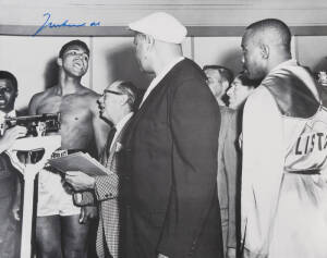 MUHAMMAD ALI, signed b/w photograph of Ali at weigh-in with Sonny Liston, size 51x41cm. With CoA.