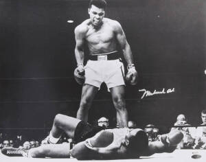 MUHAMMAD ALI, signed b/w photograph of Ali standing over Sonny Liston, size 51x41cm. With 'Online Authentics' No.OA-0000601.