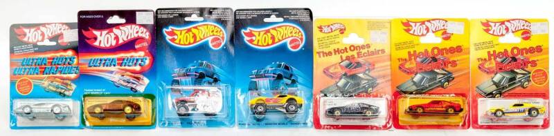 MATTEL: Group of Hotwheels 1980s Including 'Hot Ones' Torino Tornado (9533); And, 'Ultra Hots' (9537); And, 'Hot Ones' 1982 Supra (3925); And, 'Crack-Ups' Top Bopper (7582). All mint and unopened on original cardboard cards. (18 items)