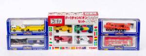 TOMICA: Group of Model Cars and Trucks Including 'Long Tomica' Tadano Hydro Crane TG 452 (L5) Orange; And, American Lafrance Aeraial Ladder (L10) Yellow; And, F1 Champion 4 Peice Set. All mint in original cardboard packaging. (5 items)